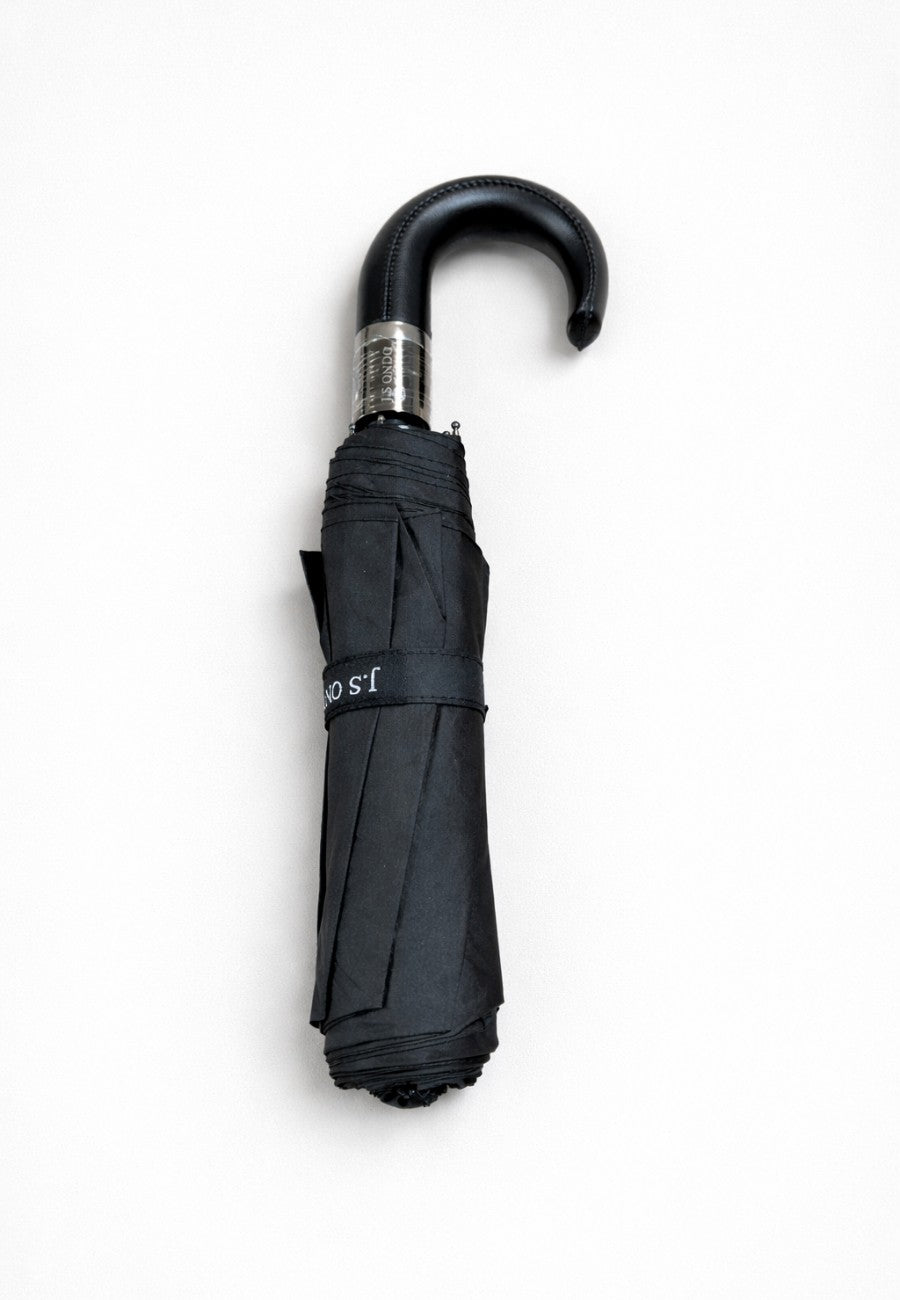 Paraguas plegable negro con mango de piel anti viento