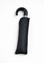Paraguas plegable negro con mango de piel anti viento